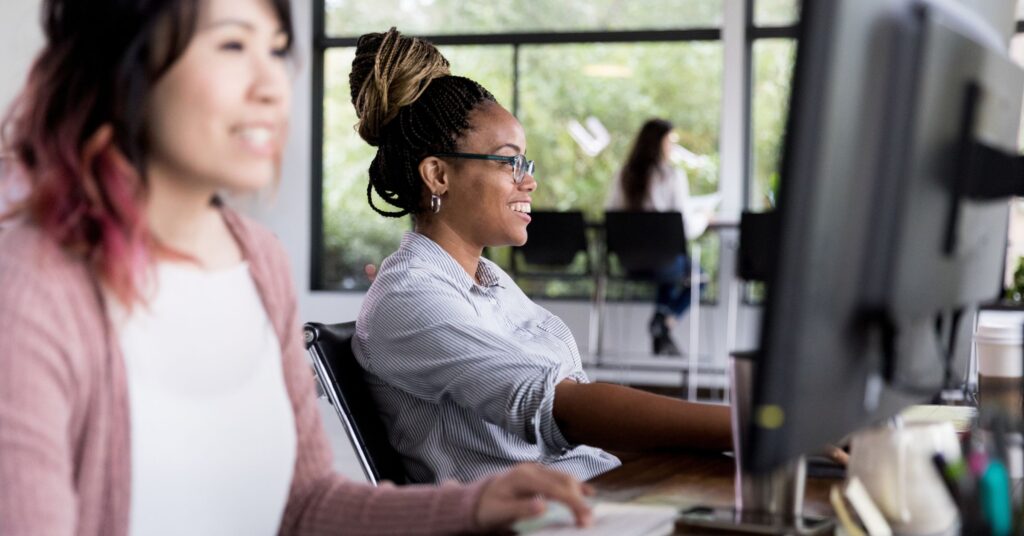 Legals ops and ai for legal teams - smiling workers at their desks