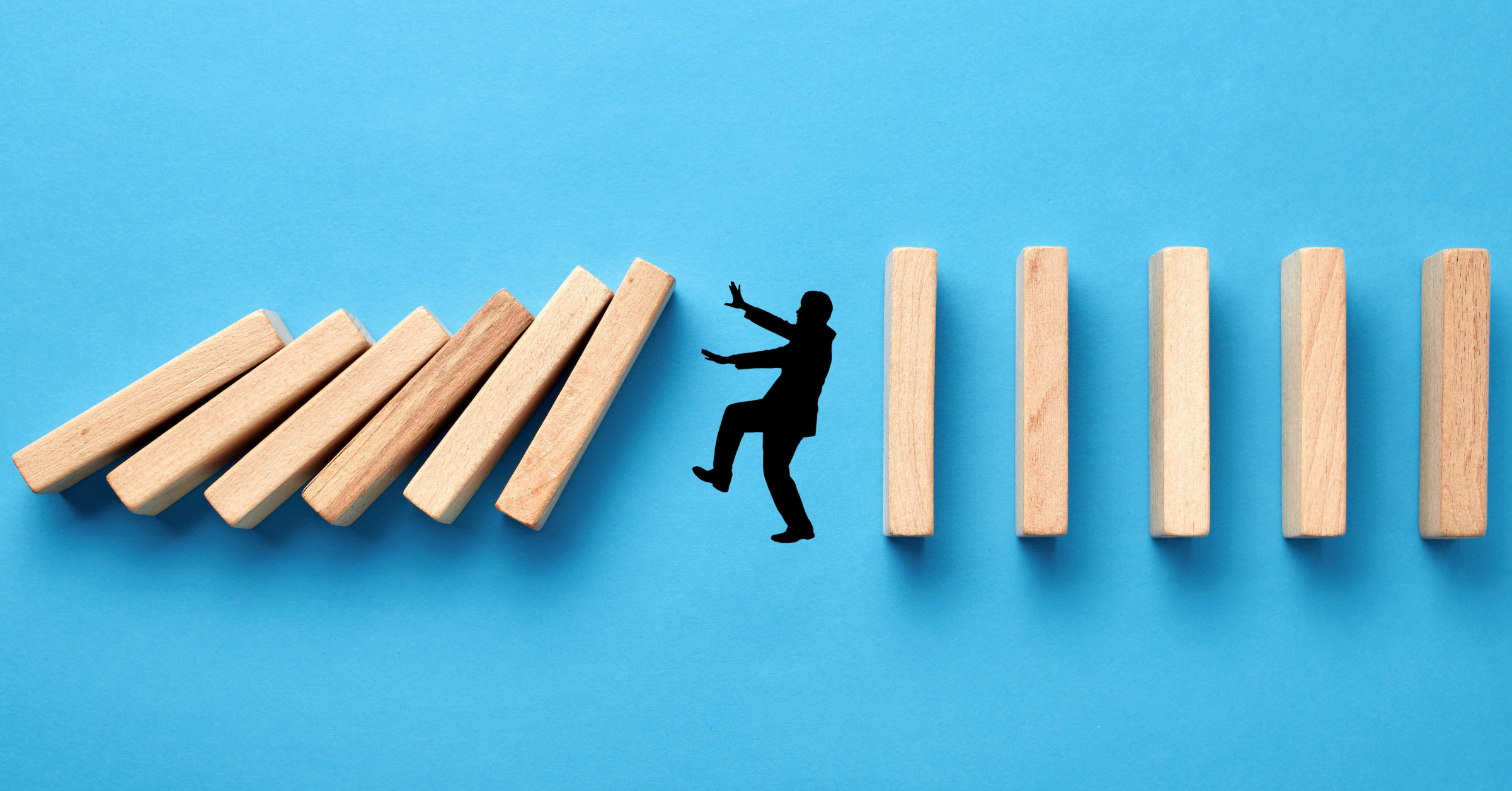 Falling dominoes halted by a gap in the sequence, symbolizing how strong legal hold processes prevent compliance risks, preservation failures, and litigation challenges.