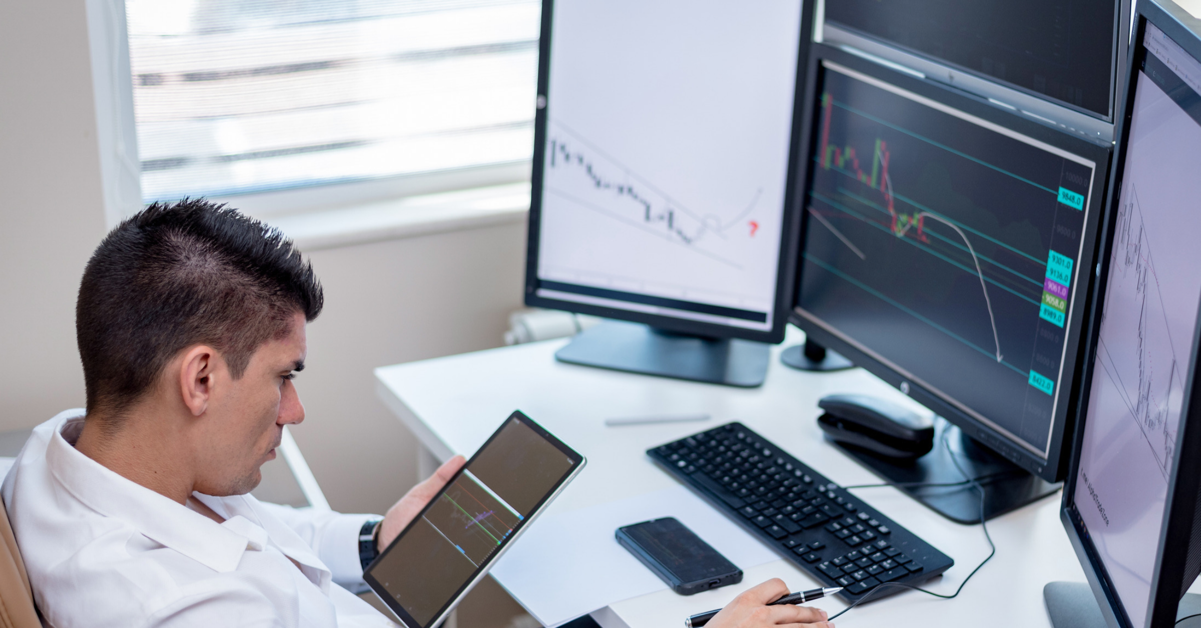 University legal operations professional reviewing data across multiple screens, illustrating the complexity of disconnected systems and reporting.